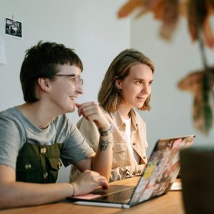 Two young professionals brainstorming together in a modern workspace with natural light.